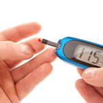 A person pricks their finger for a blood sugar test