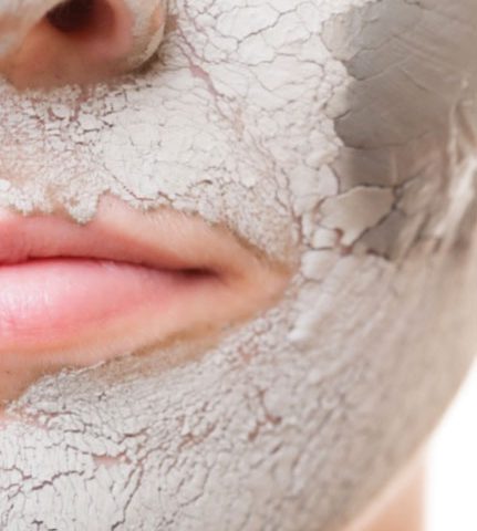 Woman wears bentonite clay face mask