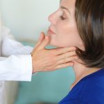 A woman having a thyroid examination.