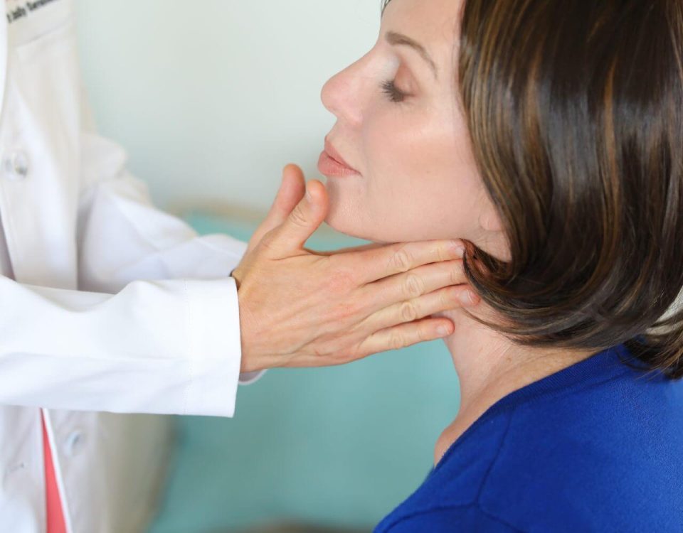 A woman having a thyroid examination.