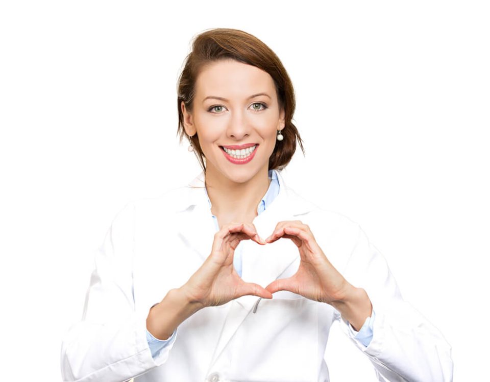 A doctor in a white lab coat making a heart symbol.